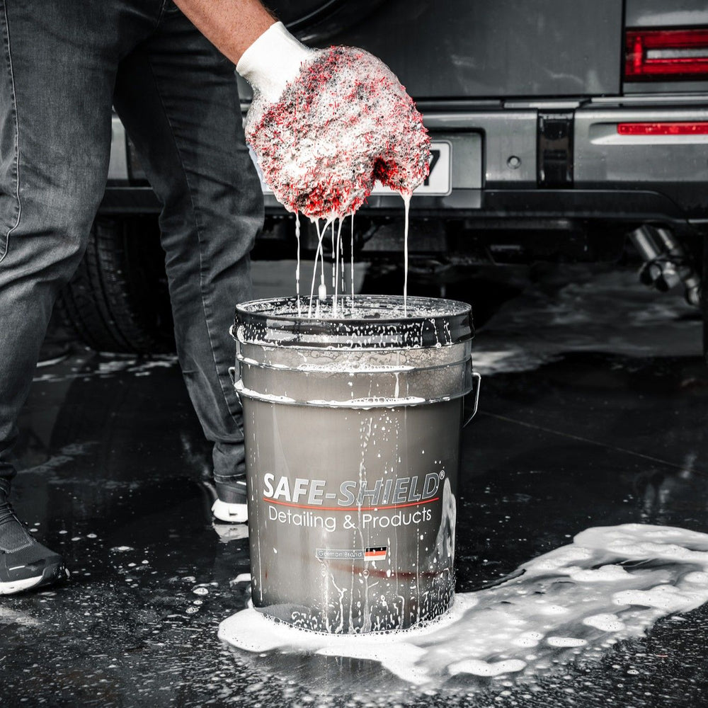 Wash mitt being rinsed in a wash bucket